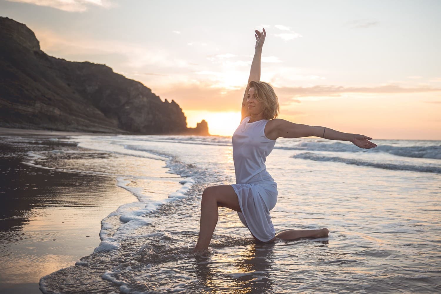 Nina Krüger macht eine Yogapose am Strand.